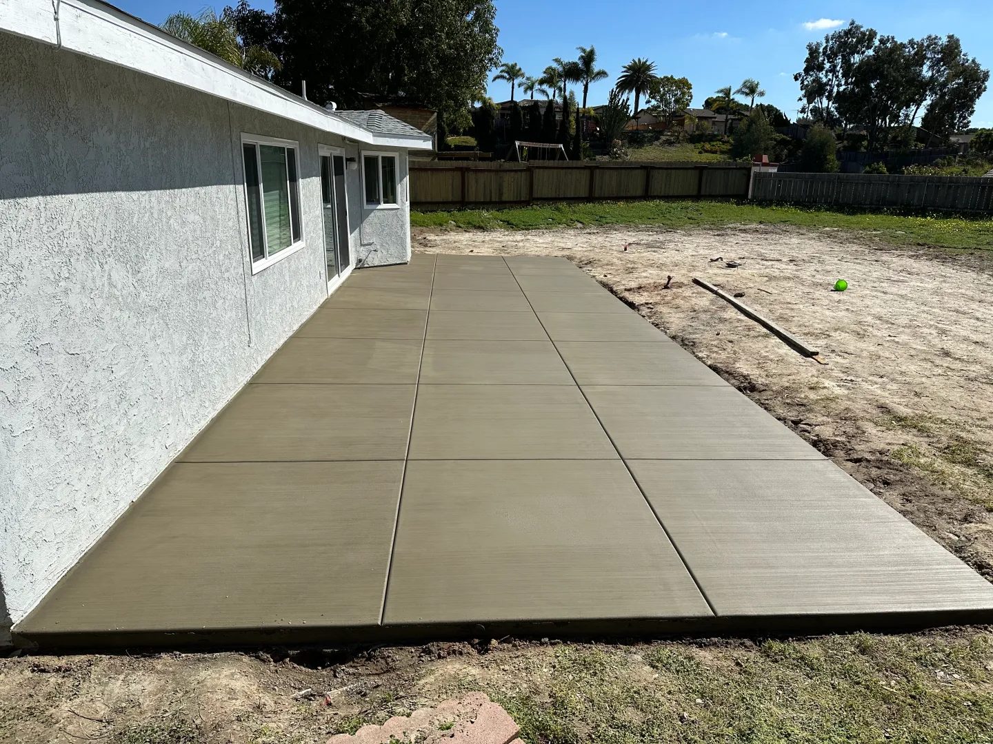 Backyard concrete patio with broom finish
